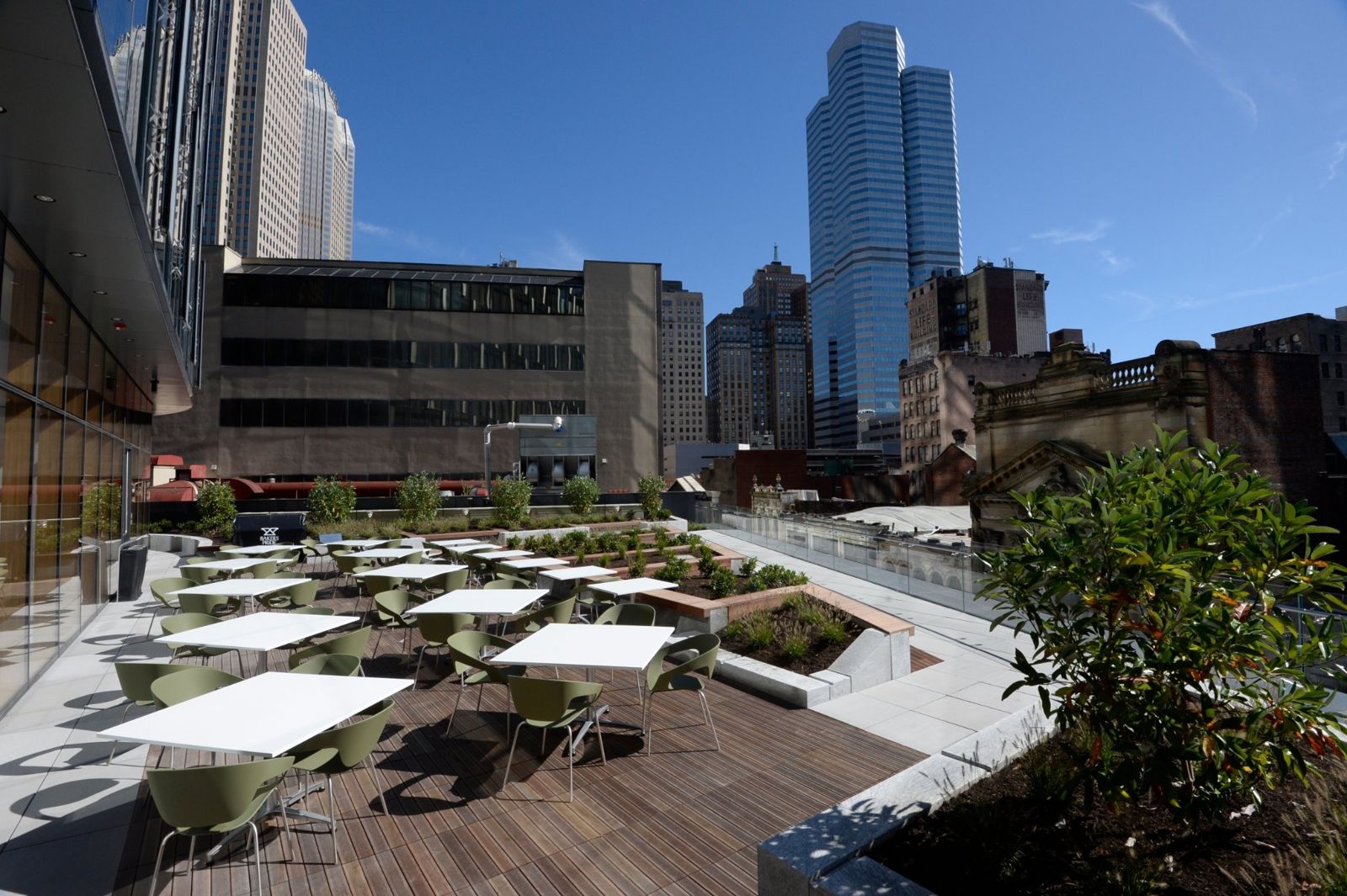 PNC Financial Services: Outdoor terrace with white tables and umbrellas above the street