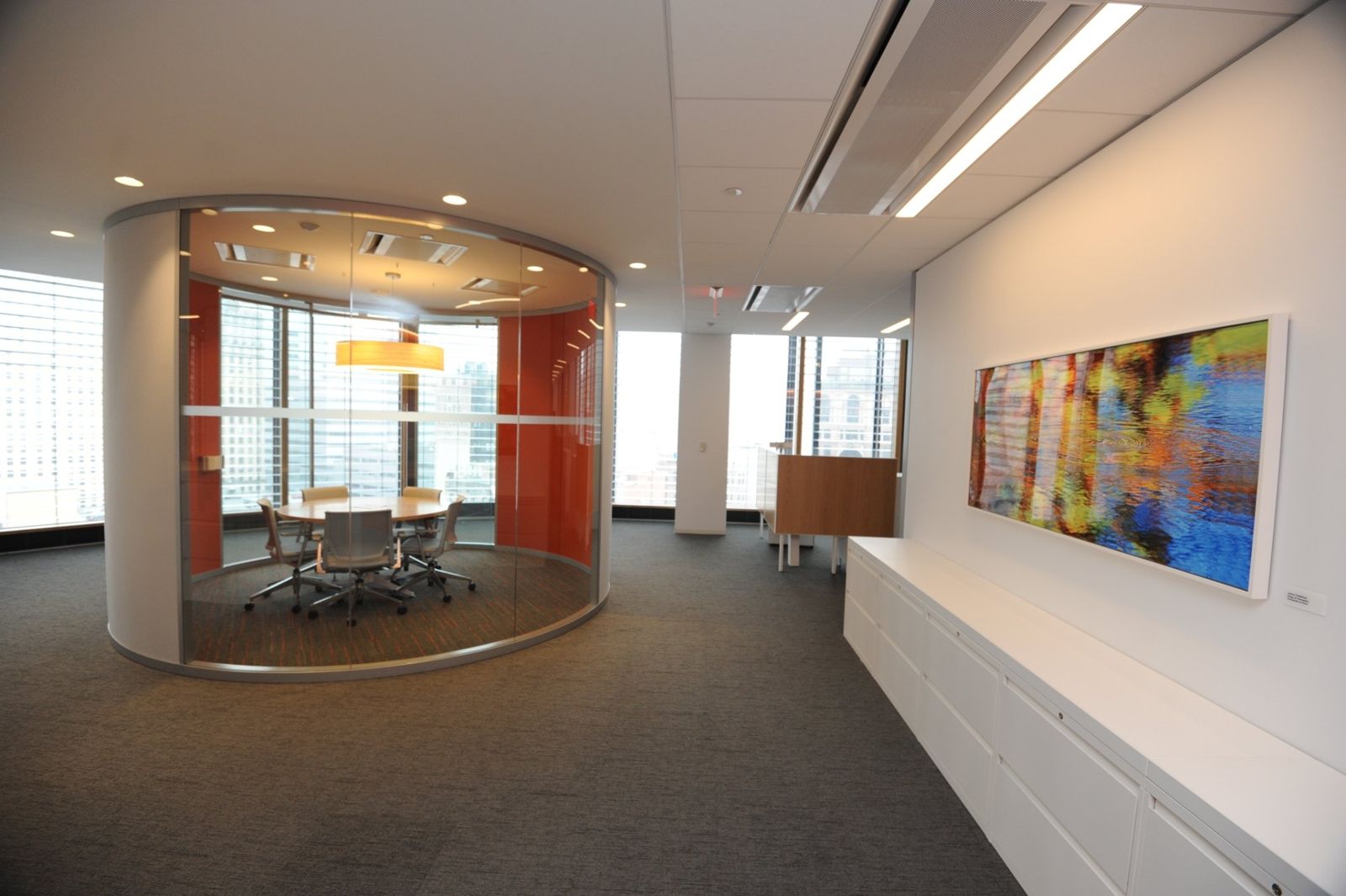PNC Financial Services: Round glass-walled meeting room with an orange wall