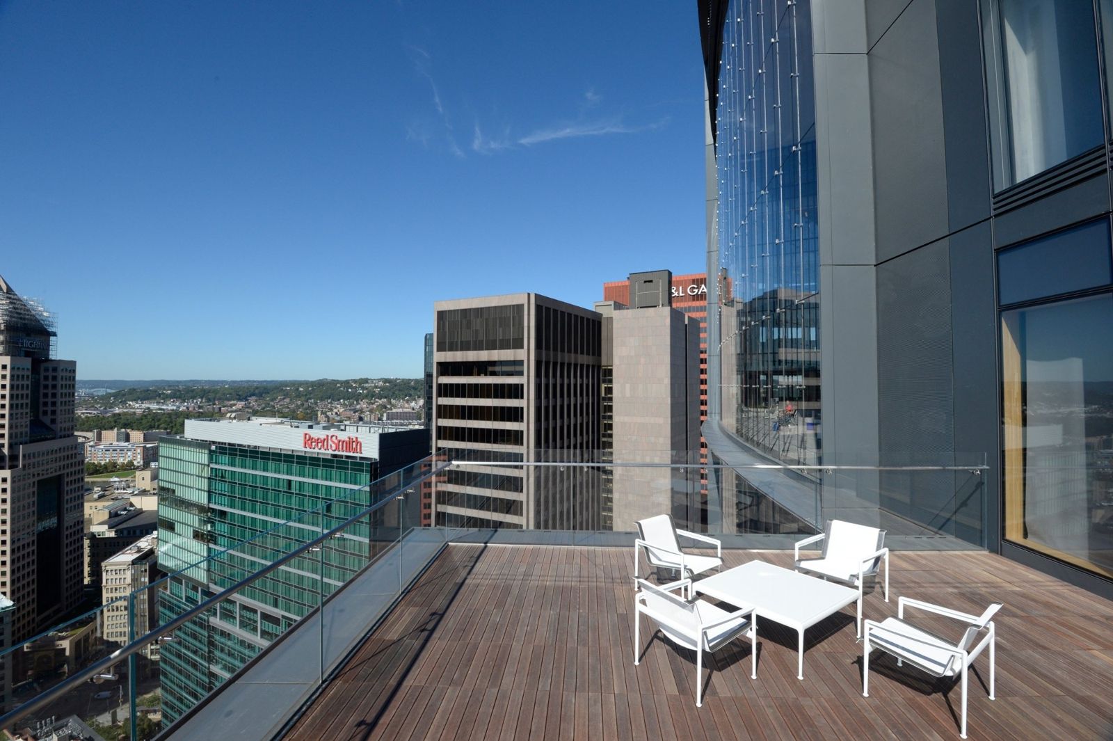 PNC Financial Services: Wooden deck with white chairs overlooking downtown