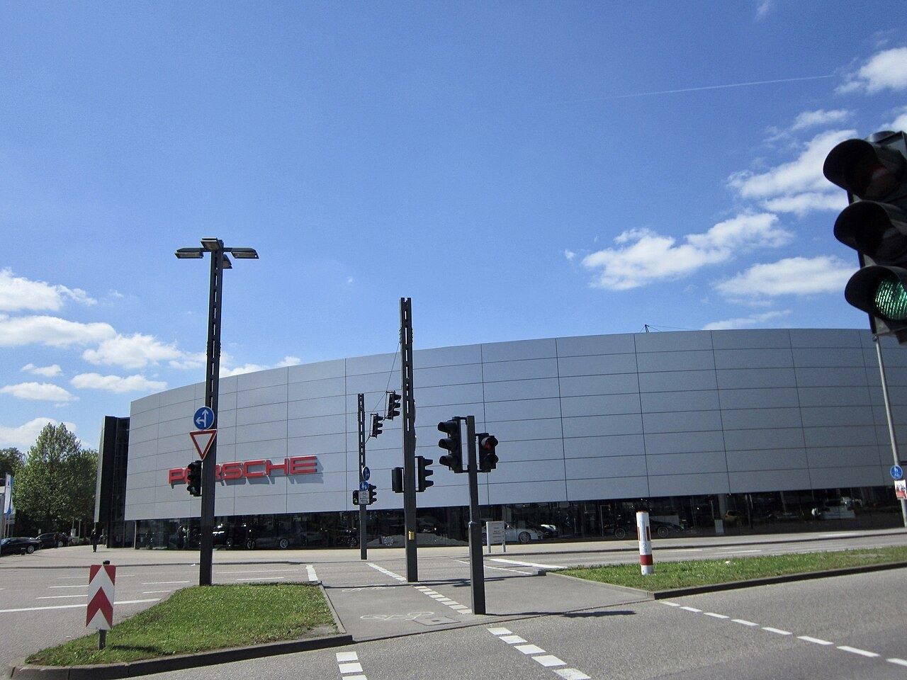 Silver building with a large Porsche sign