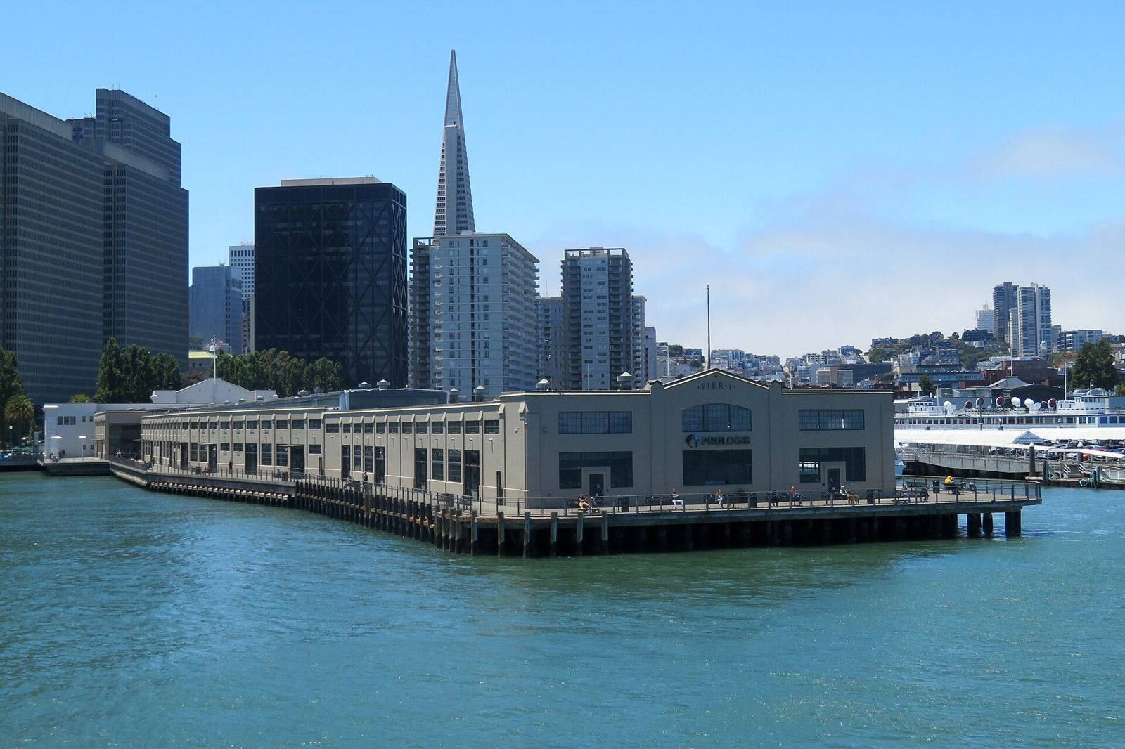 Prologis: A long low pier building on the bay with the Transamerica Pyramid and downtown towers behind