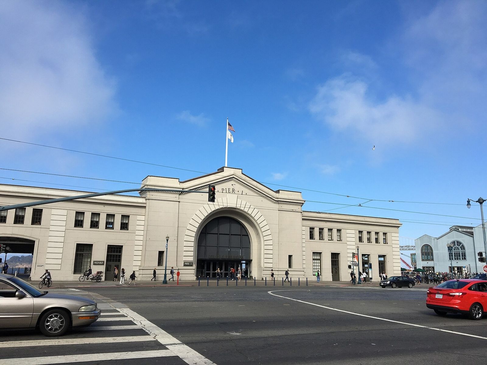 Prologis: Pier 1 with its arched entrance under a blue sky with clouds