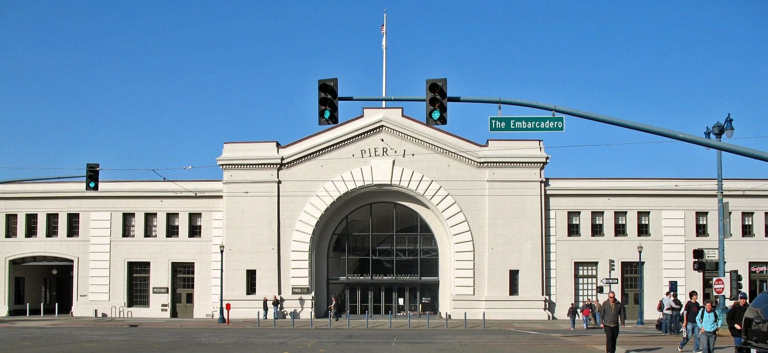 Prologis: The arched front of Pier 1 seen across the Embarcadero with traffic lights