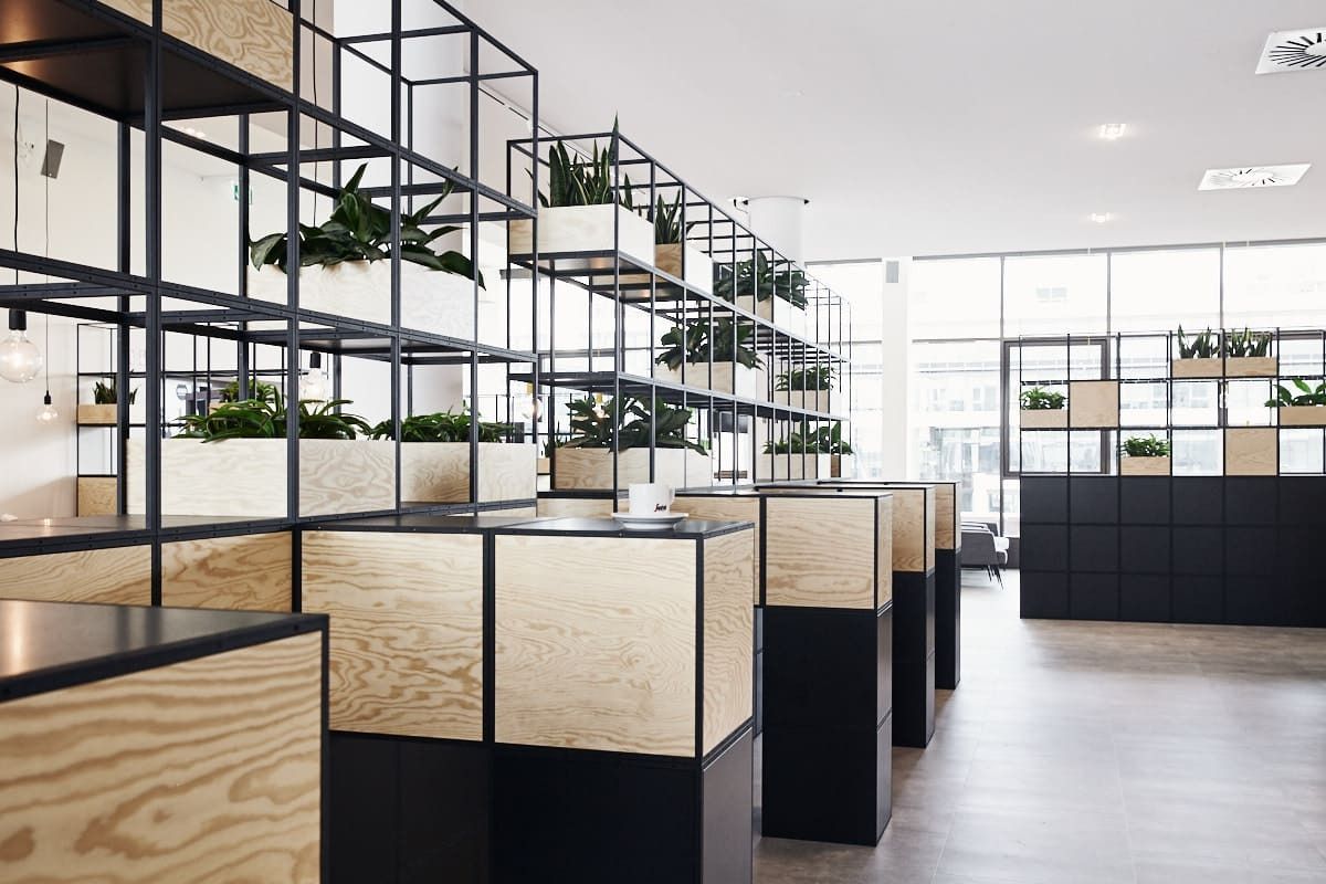 PUMA: Desks divided by plywood and steel shelf units