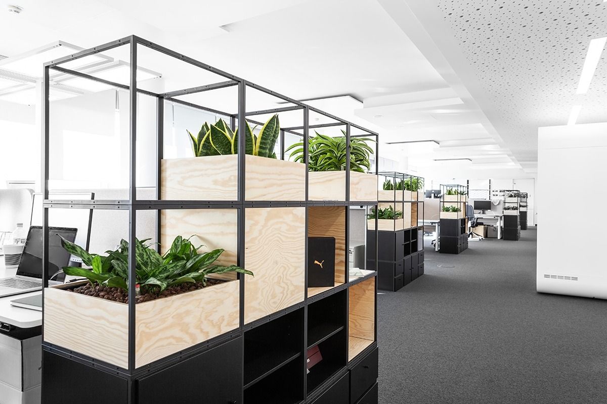 PUMA: Planters on top of steel-frame shelves in an open office