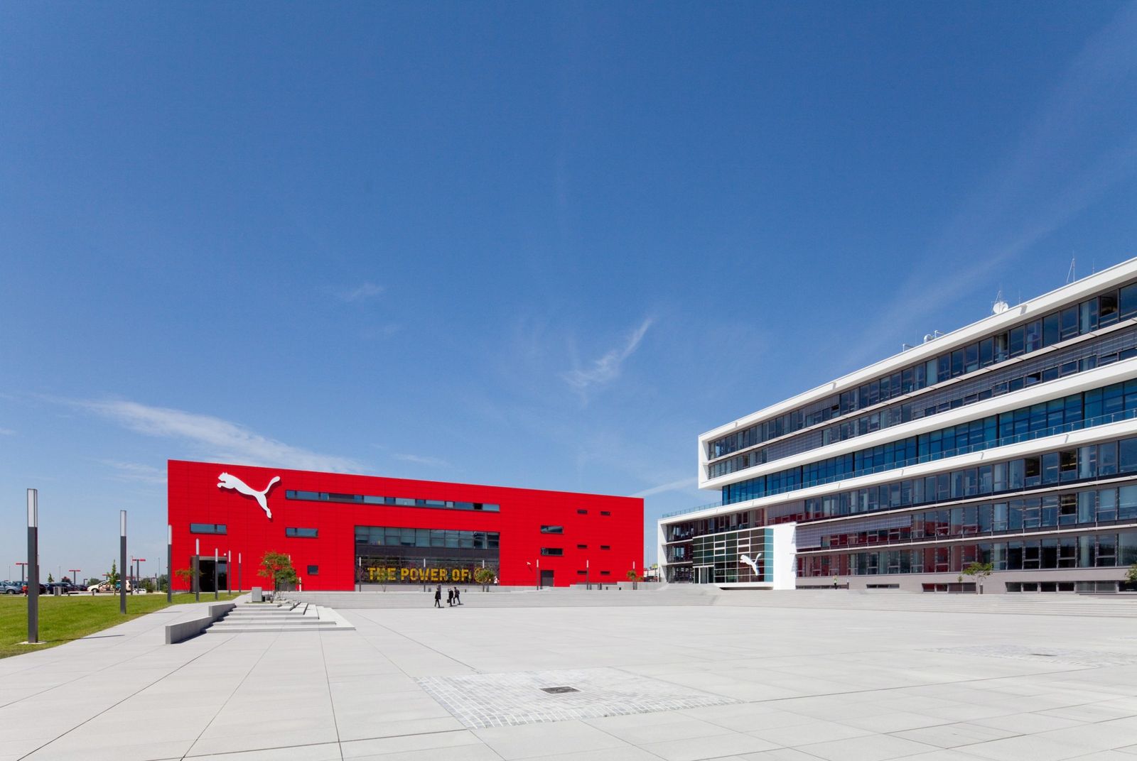 PUMA: Red building with the PUMA cat logo across a wide paved plaza
