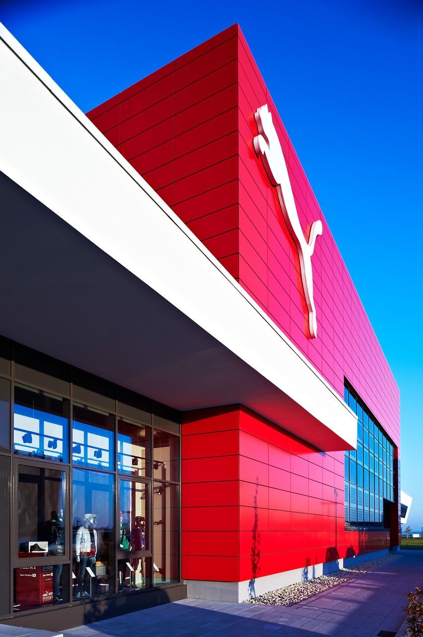 Red-clad building corner with the cat logo