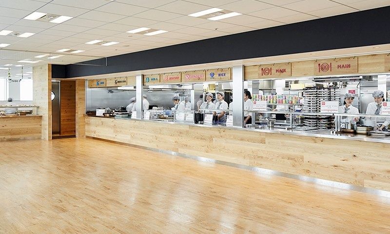 Rakuten Group: Cafeteria serving counters along a wooden floor