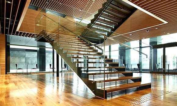 Rakuten Group: Glass and timber staircase in a bright double-height space