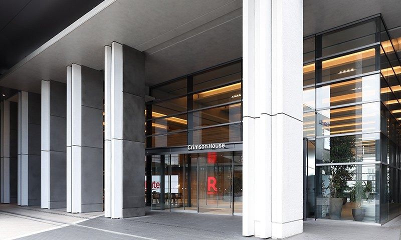 Rakuten Group: Glass entrance between white columns