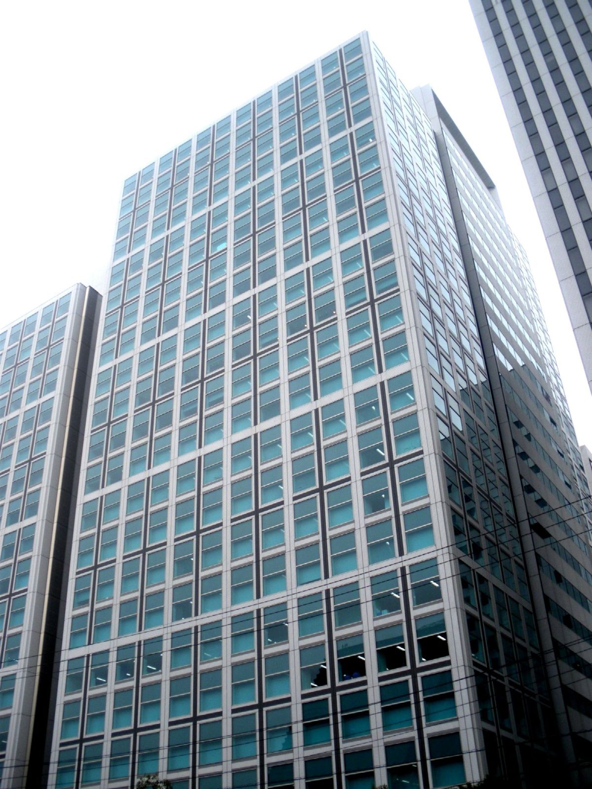 Glass office tower seen from below