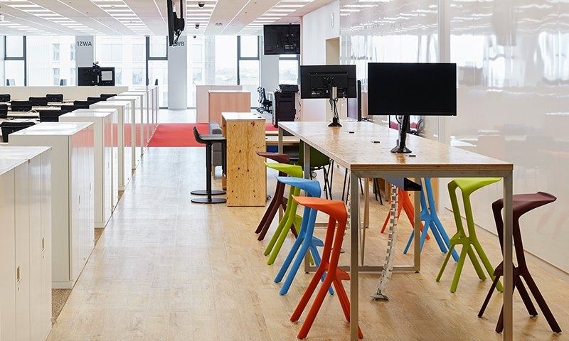 Rakuten Group: Standing desks with monitors and colourful high stools