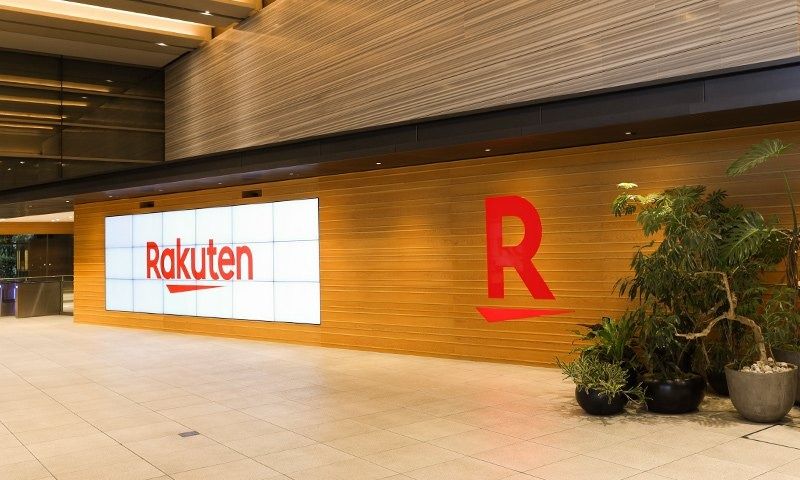 Rakuten Group: Wood-panelled lobby with a large Rakuten screen and red R logo