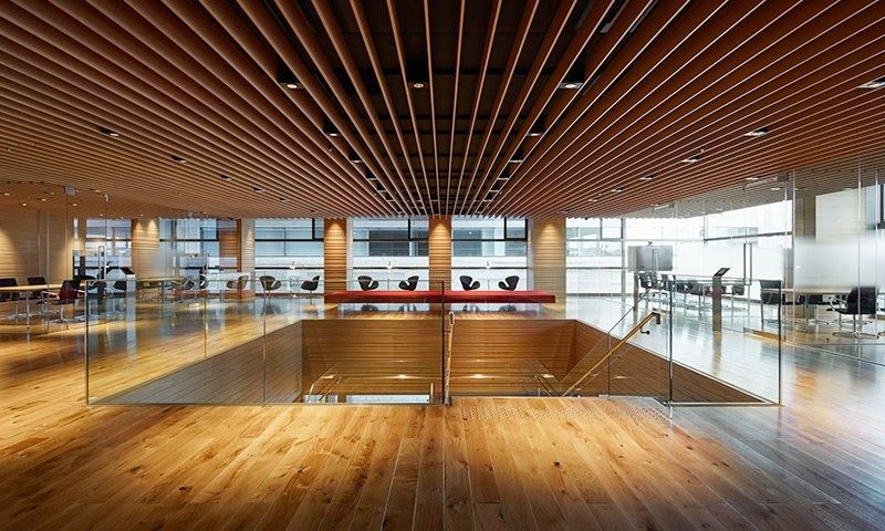 Rakuten Group: Wood-slatted hall with an open stairwell and timber floor