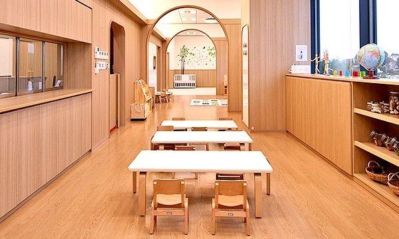 Rakuten Group: Wooden room with small tables and chairs for children