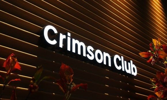 Rakuten Group: Wooden wall with the words Crimson Club