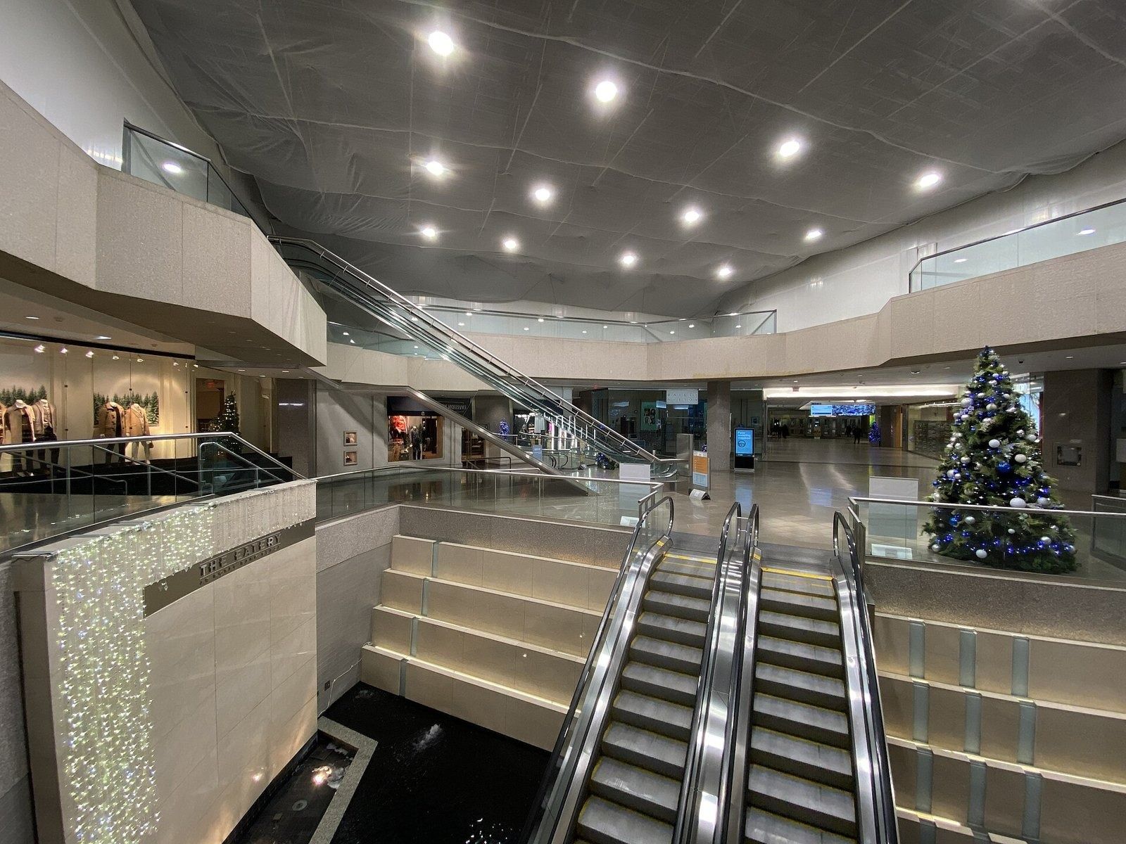 RBC (Royal Bank of Canada): Escalators and lit steps in a wide concourse with a Christmas tree