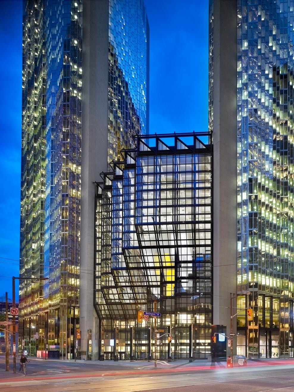 RBC (Royal Bank of Canada): Glass entrance block between two towers lit at dusk