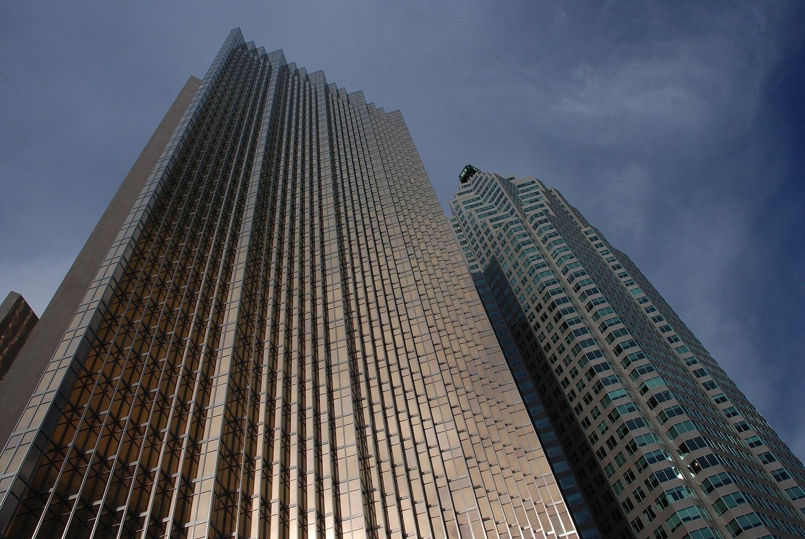 RBC (Royal Bank of Canada): Gold glass tower beside another high-rise under a grey sky