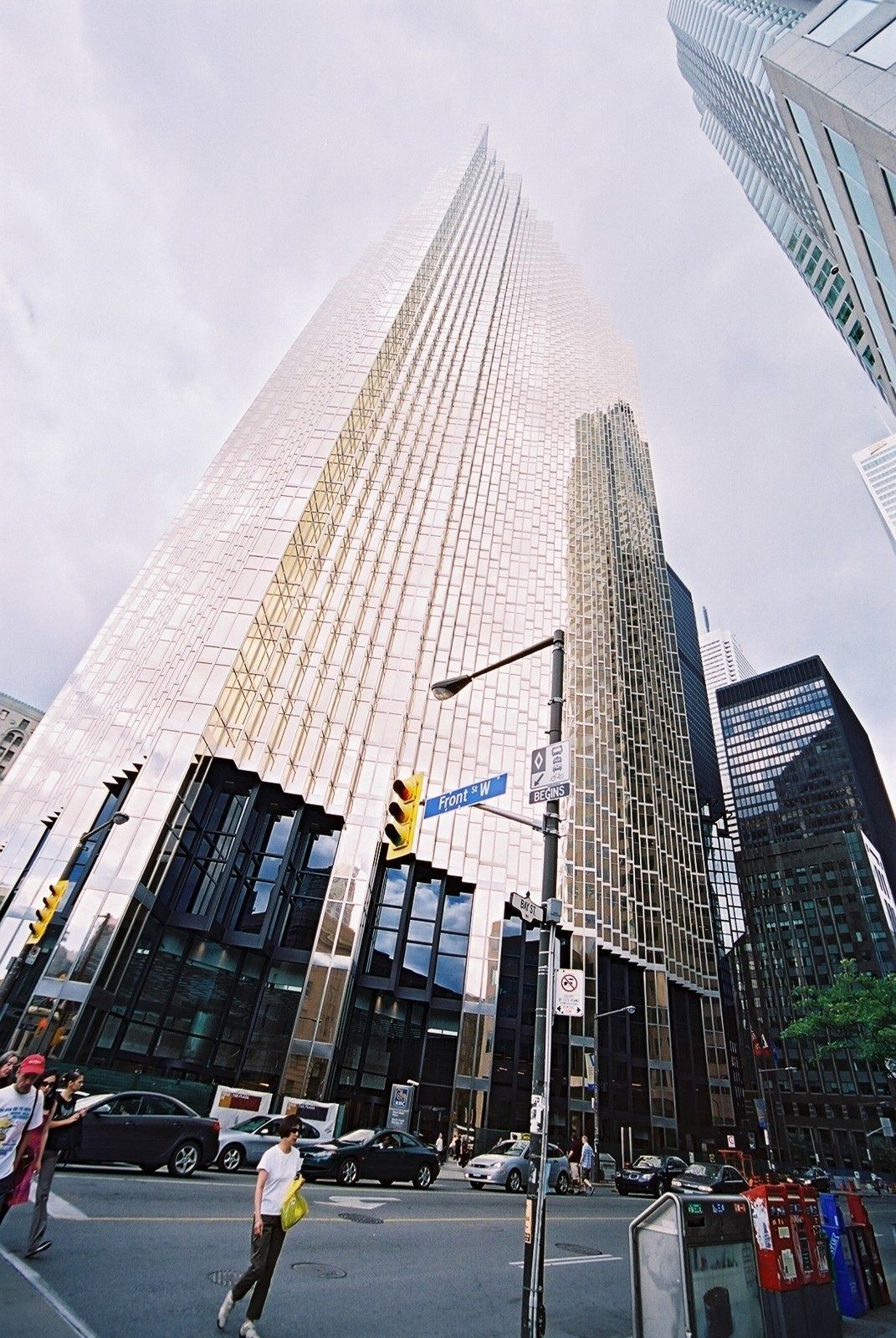 RBC (Royal Bank of Canada): Gold tower rising above a street intersection, wide-angle view