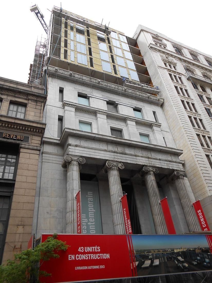Classical stone bank facade with columns on Saint-Jacques Street during conversion