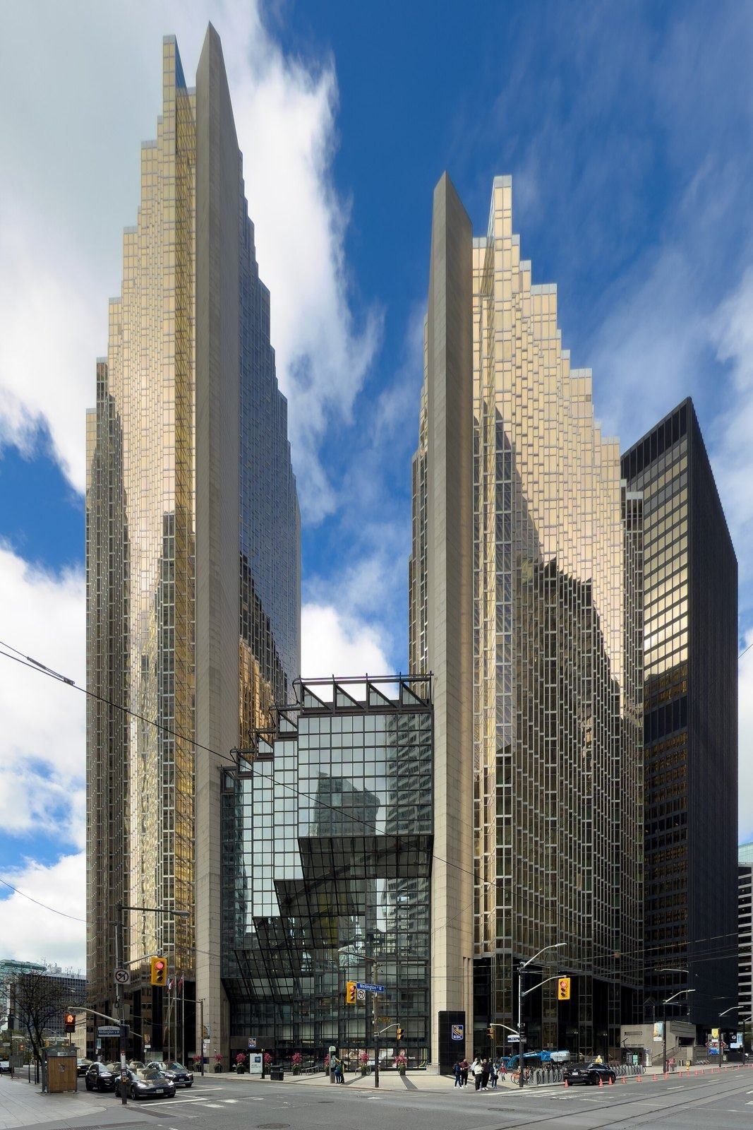 RBC (Royal Bank of Canada): Two gold glass towers framing a glass atrium at a street corner