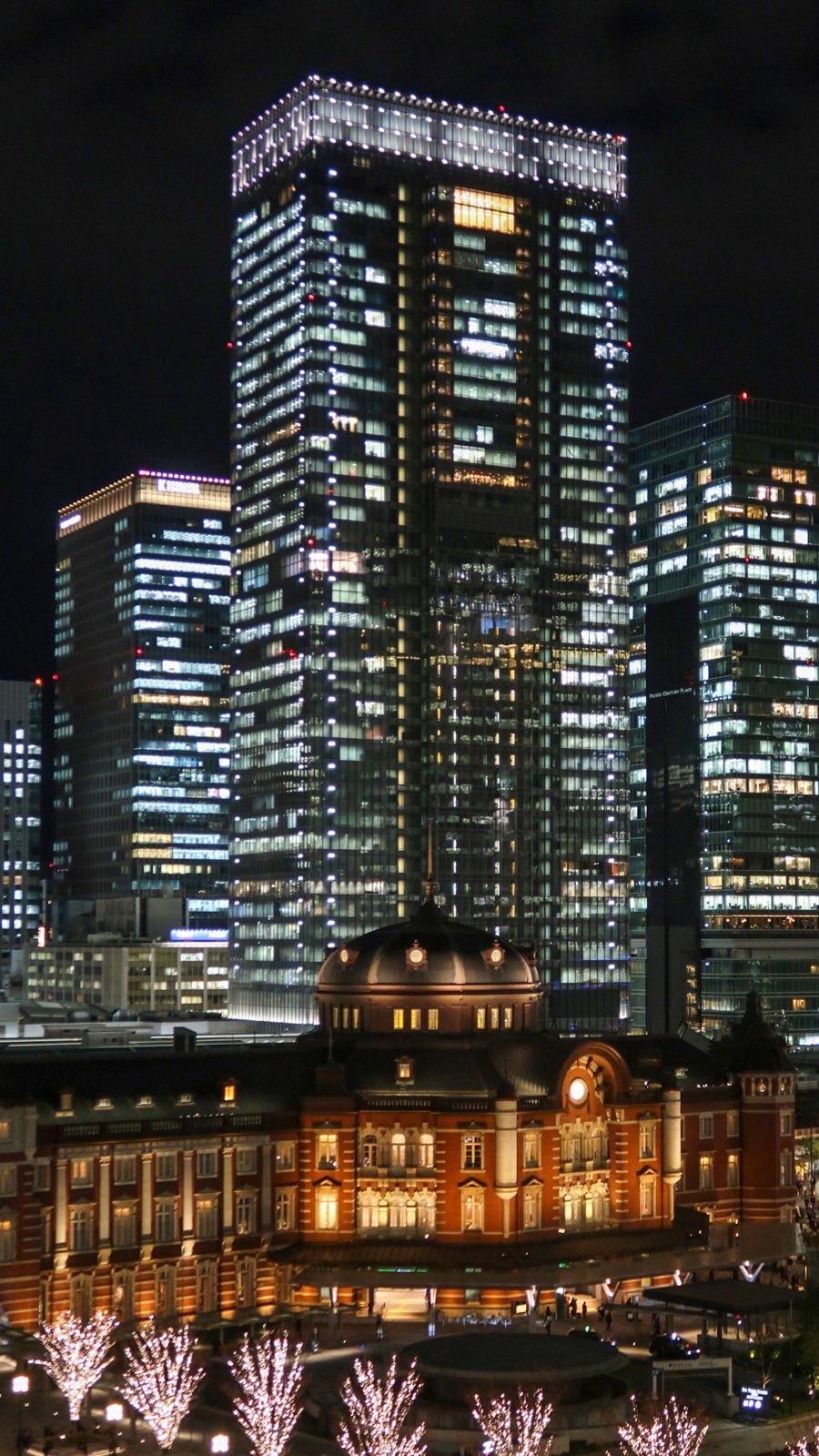 Recruit Holdings: Lit tower at night above the lit station building