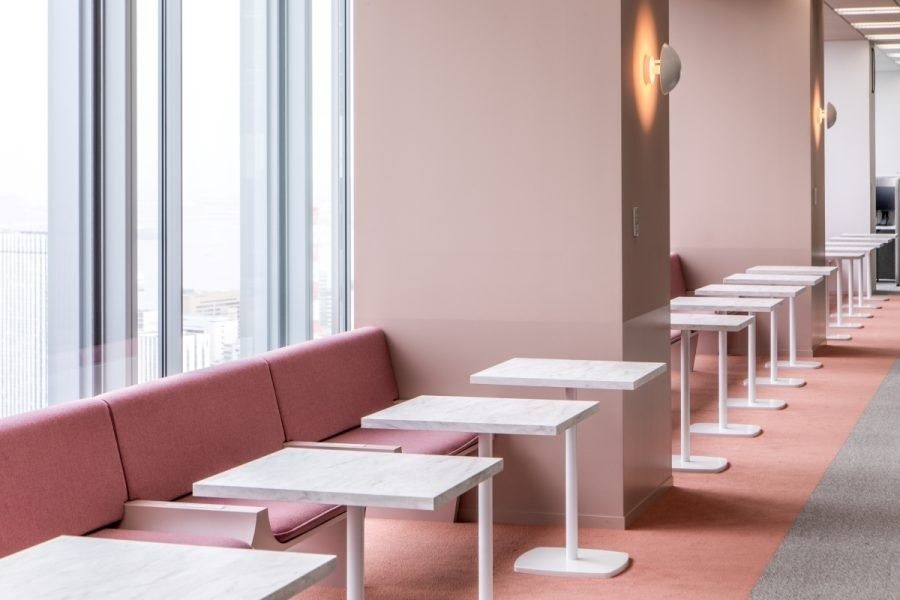 Recruit Holdings: Pink banquette with white tables along the windows