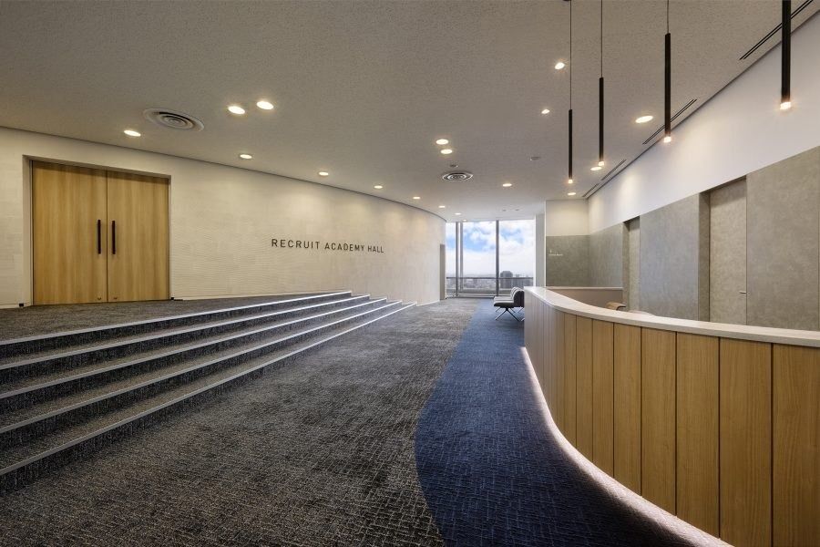 Recruit Holdings: Stepped seating and doors in a hall entrance