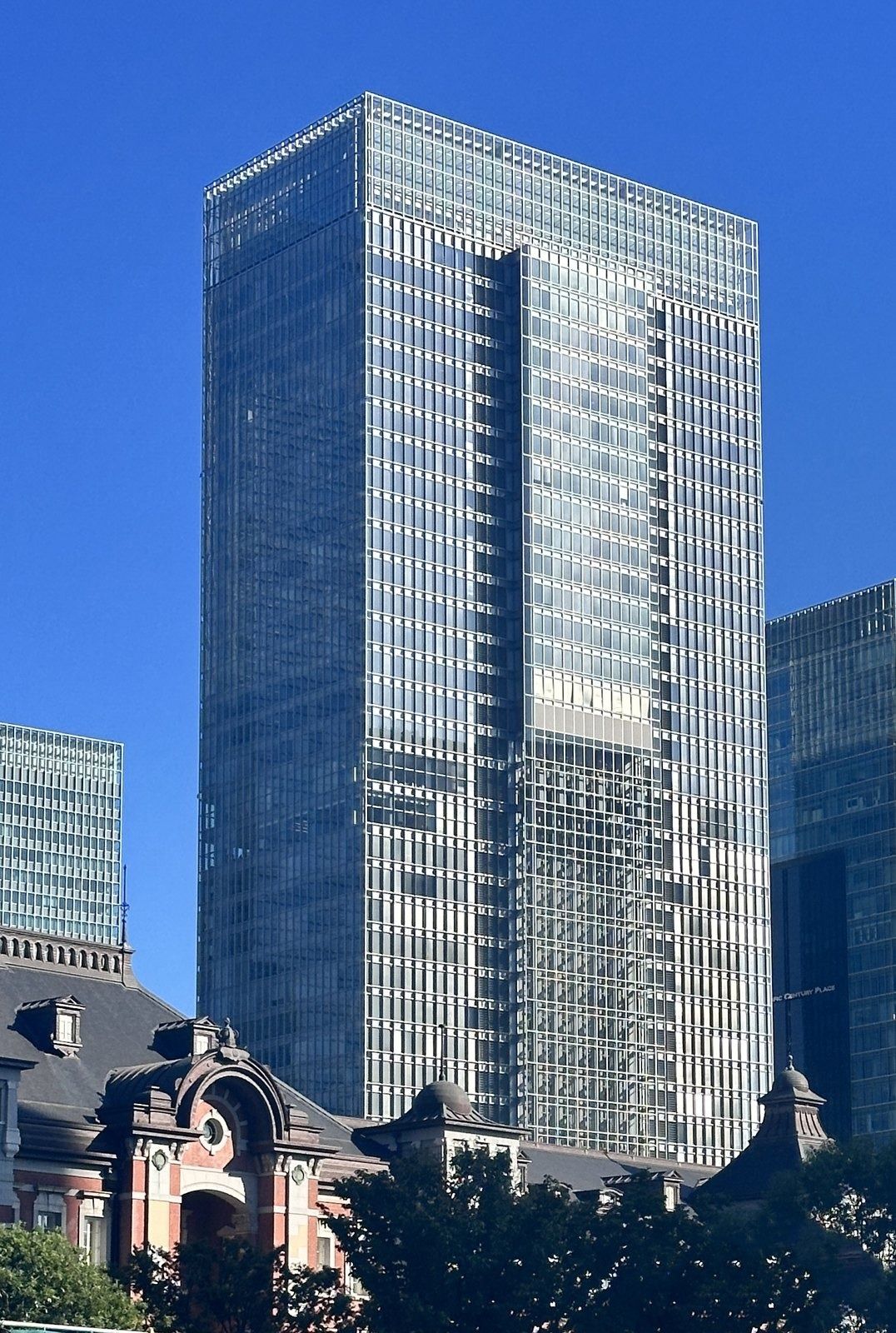 Tall glass tower above the red-brick Tokyo Station