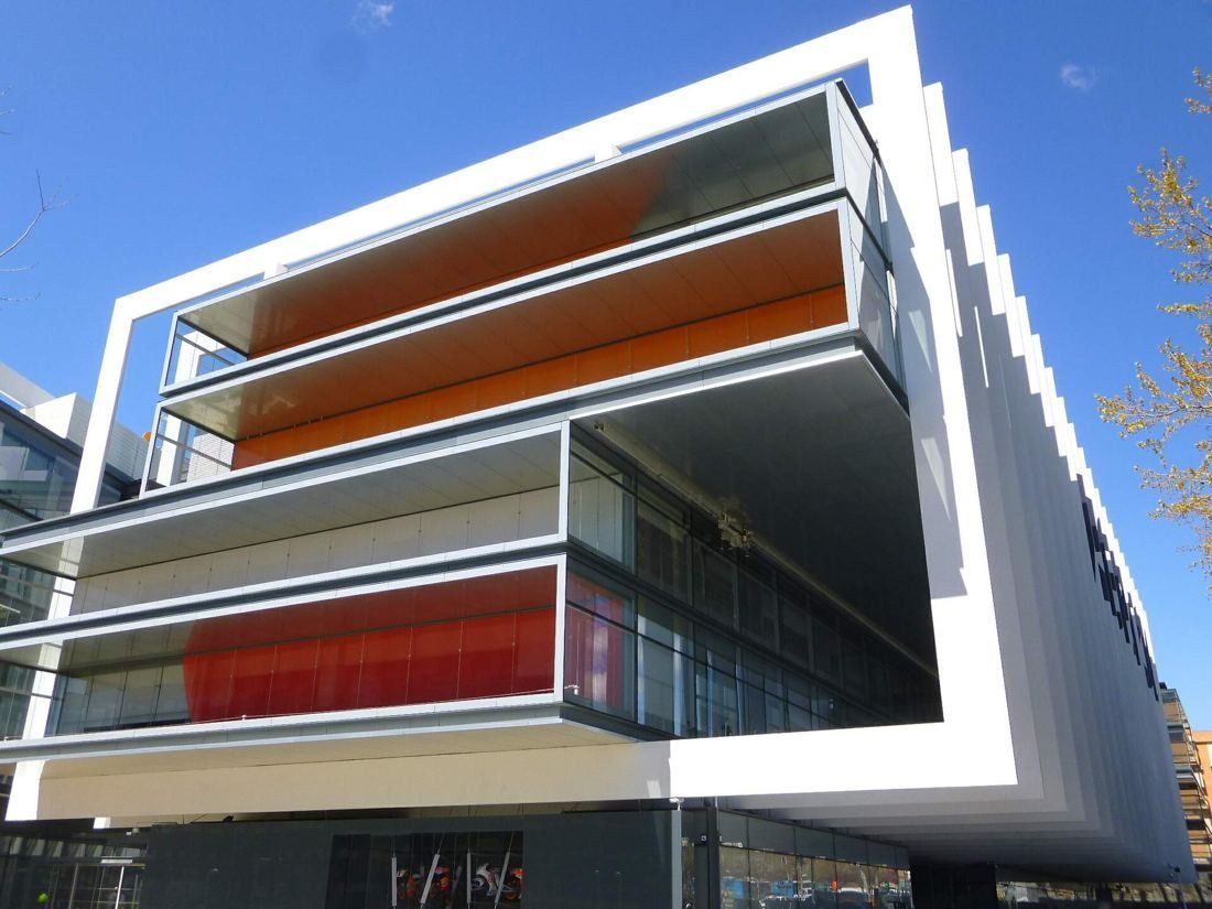 Repsol: Cantilevered glass floors with orange and red linings inside a white frame, seen from below