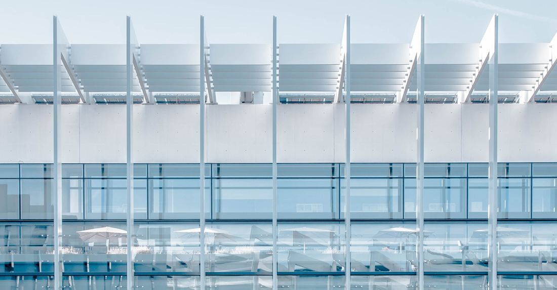 Repsol: Close view of white fins and the glass façade behind them
