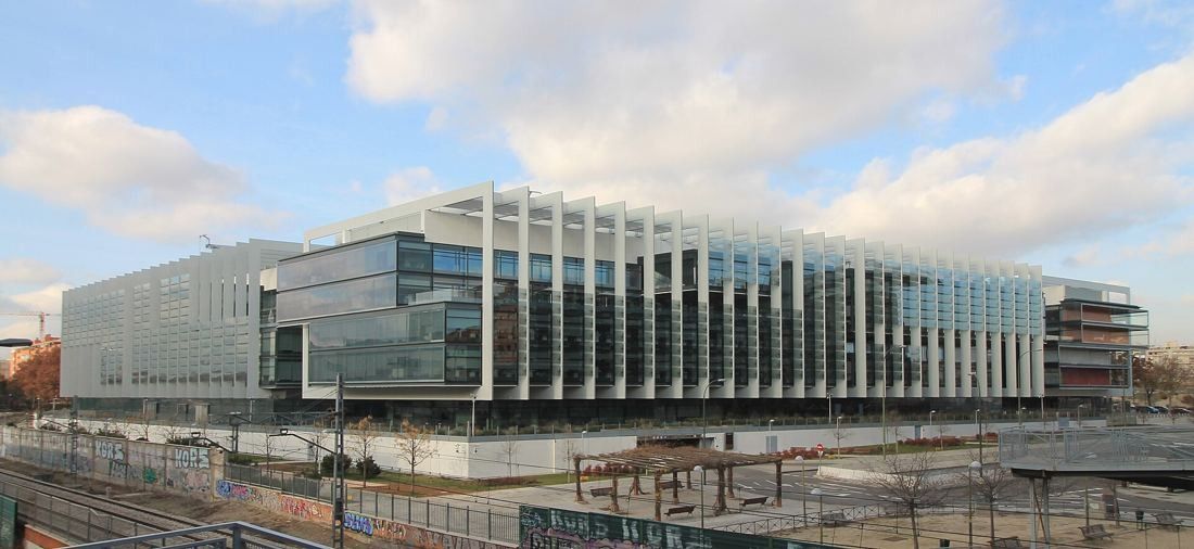 Repsol: Distant view of the low glass campus across open ground
