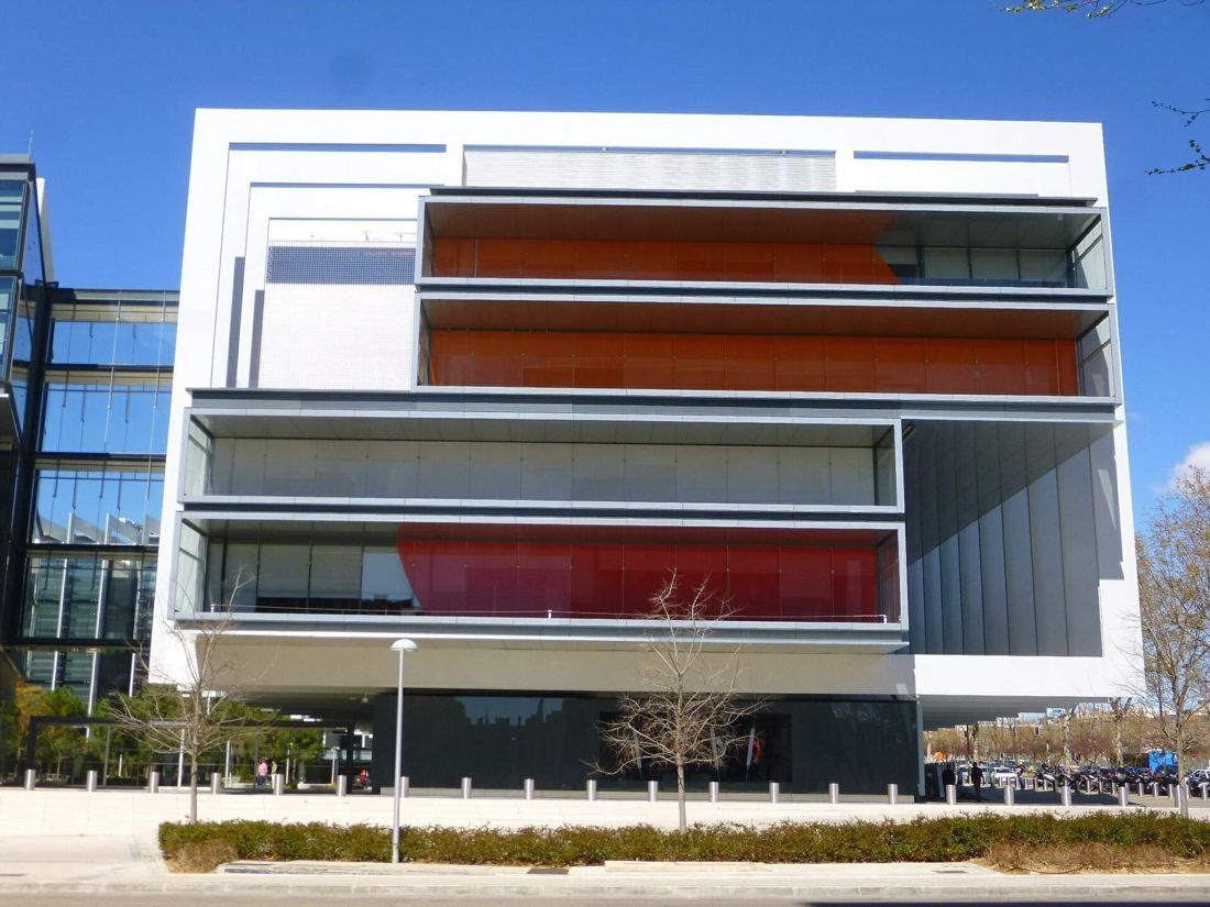 Repsol: White-framed corner block with stacked glass floors lined in orange and red