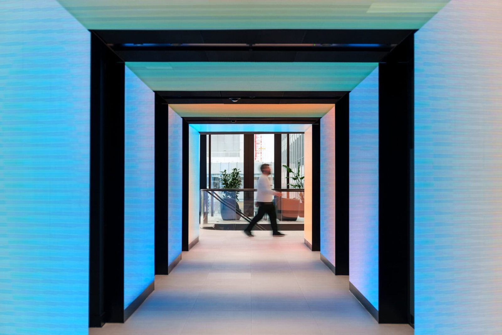 Revolut: Corridor framed by glowing blue LED walls