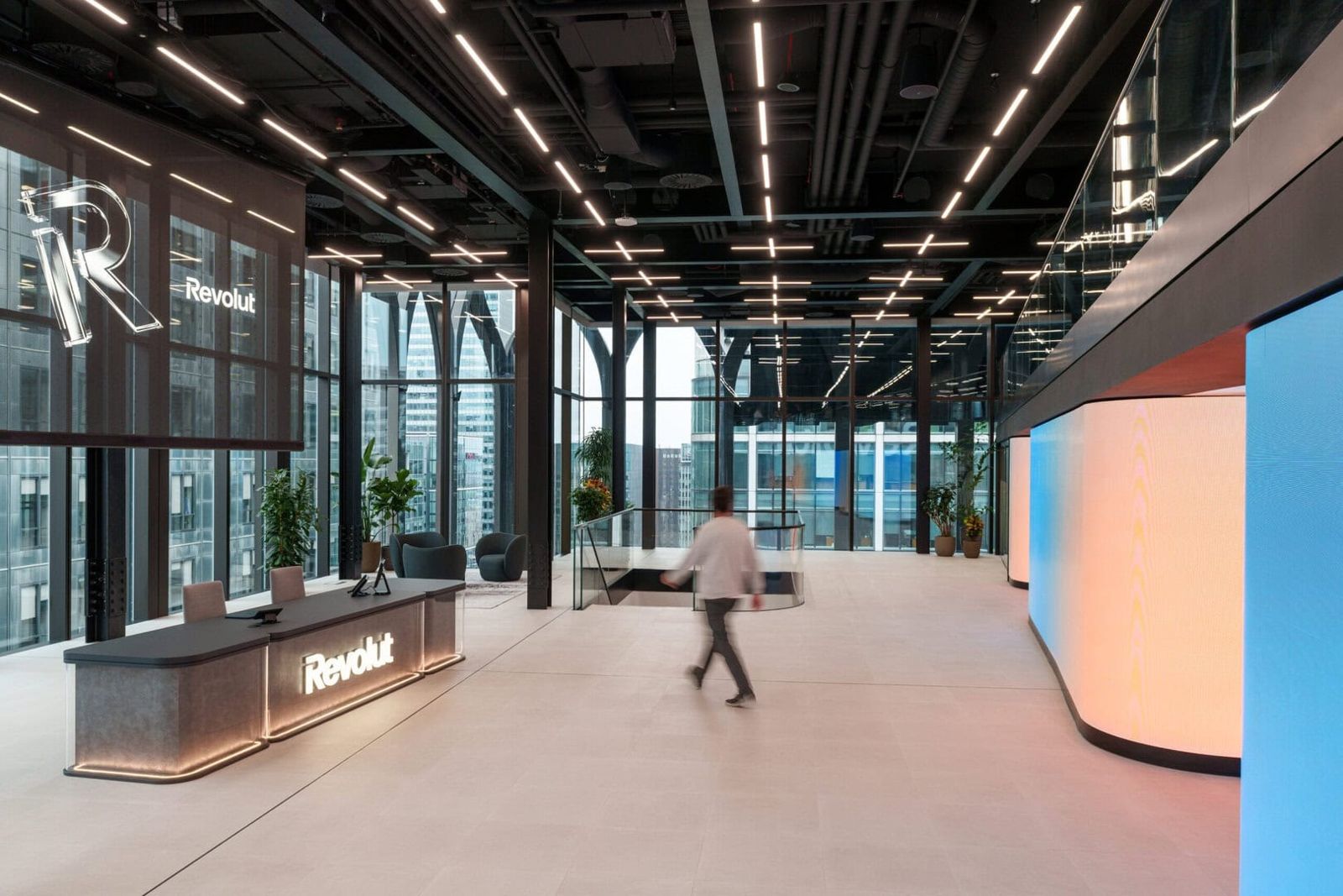 Revolut: Reception desk with the Revolut name and a glowing curved wall