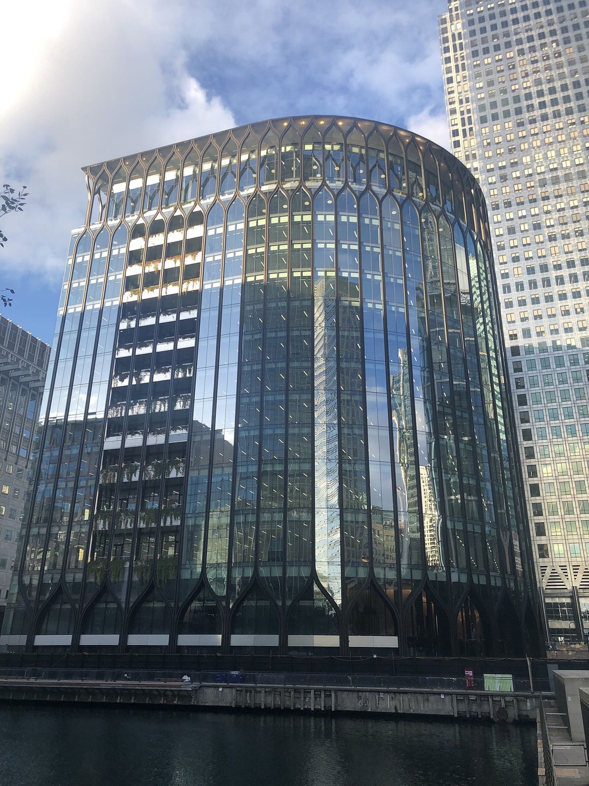 Revolut: Rounded glass facade beside a taller tower
