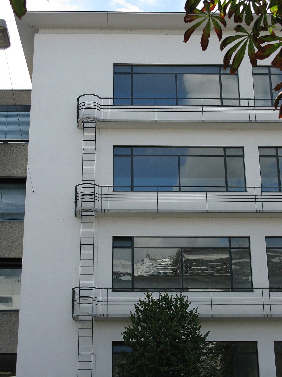 White 1930s office building with long window bands