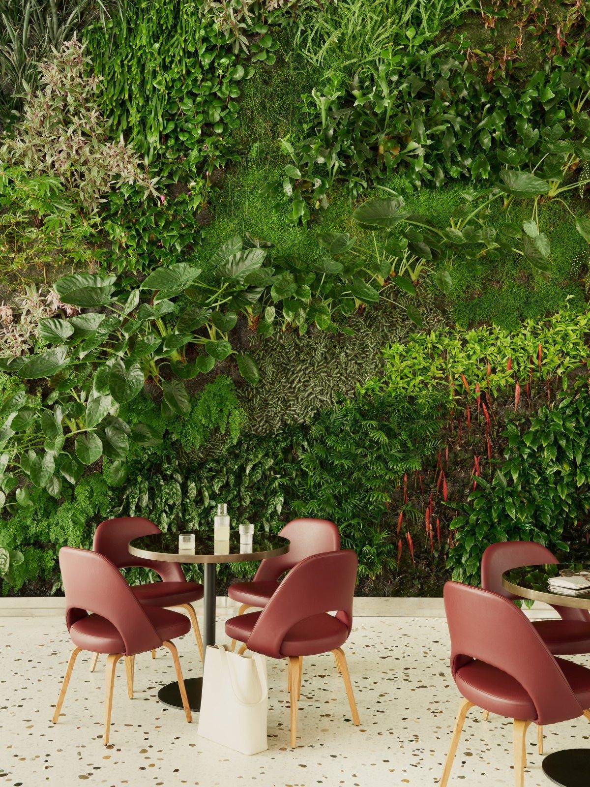 Roche: Red chairs in front of a living plant wall