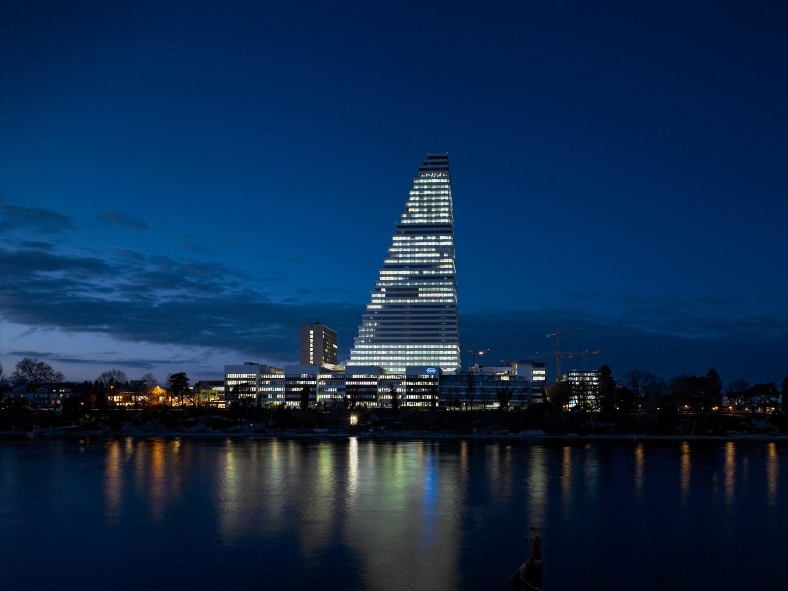Roche: Tower lit at night across the Rhine