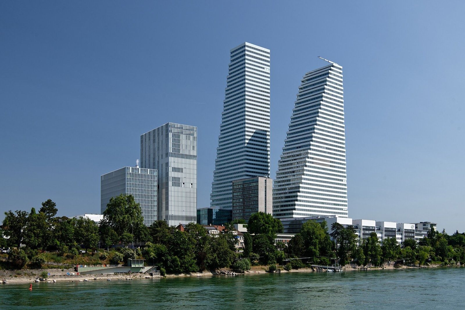 Roche: Two stepped white towers above the riverbank