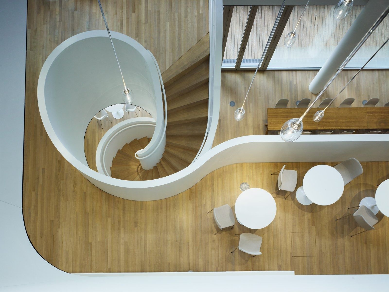Roche: White spiral staircase above a café, seen from above