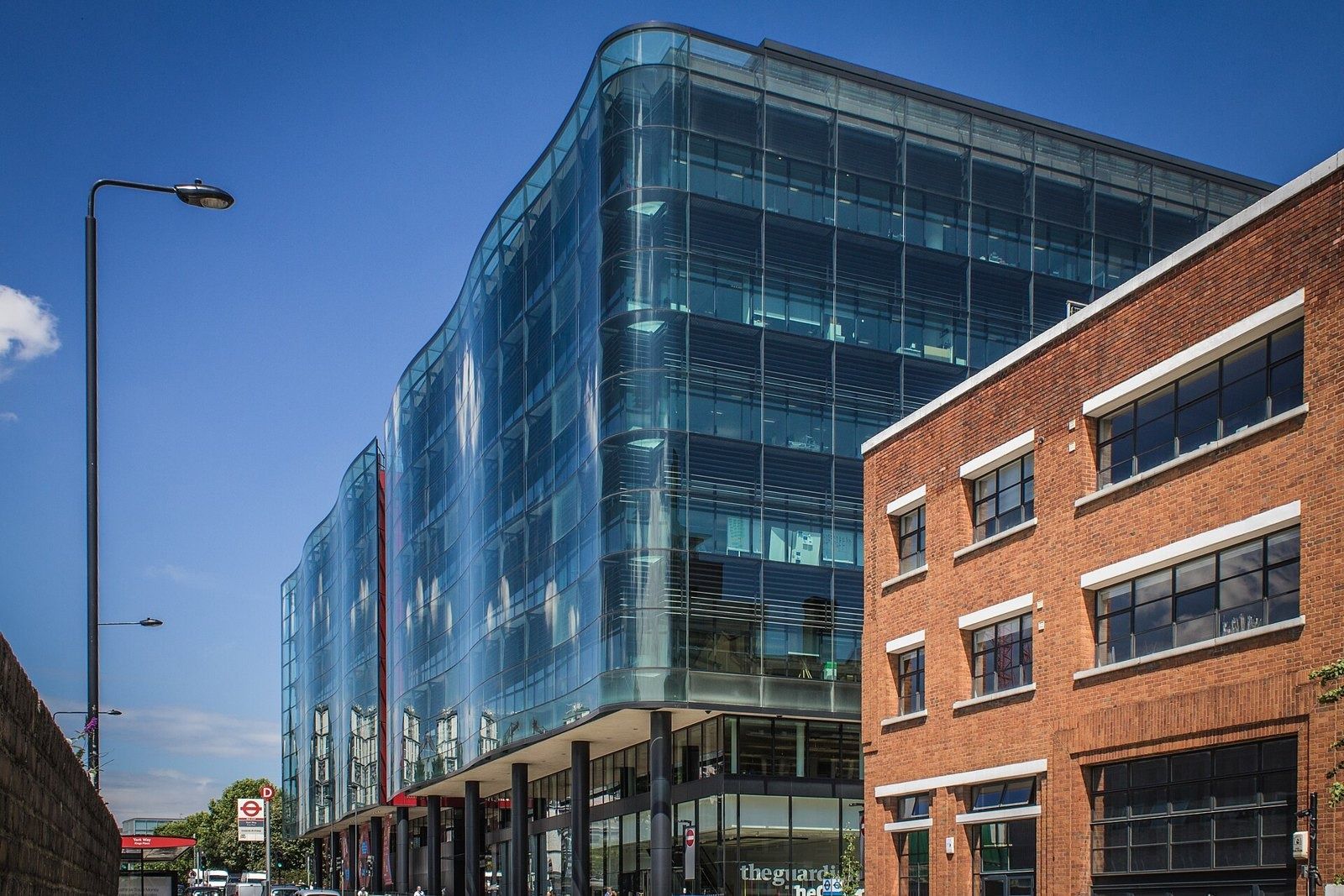 Rolls-Royce: Glass office building and brick neighbour under a deep blue sky