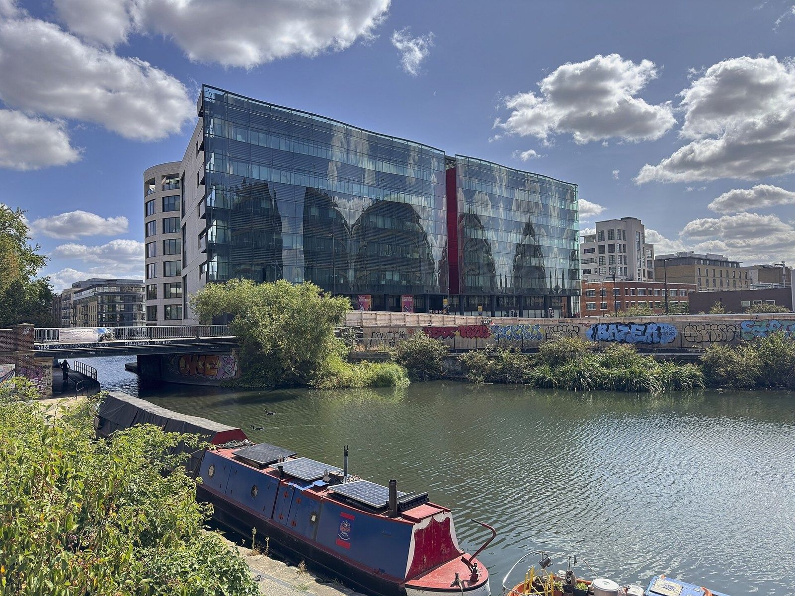 Rolls-Royce: Glass office building beyond a canal basin with a narrowboat moored in front