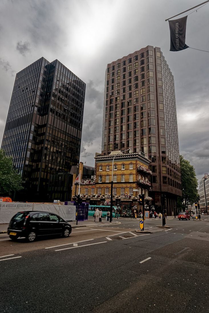 Tall office block at 65 Buckingham Gate seen from Victoria Street beside a Victorian pub