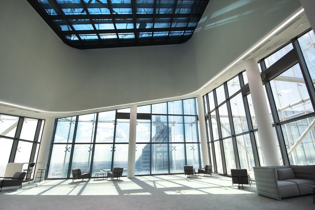 Saint-Gobain: Large empty room with a glass roof and windows all around