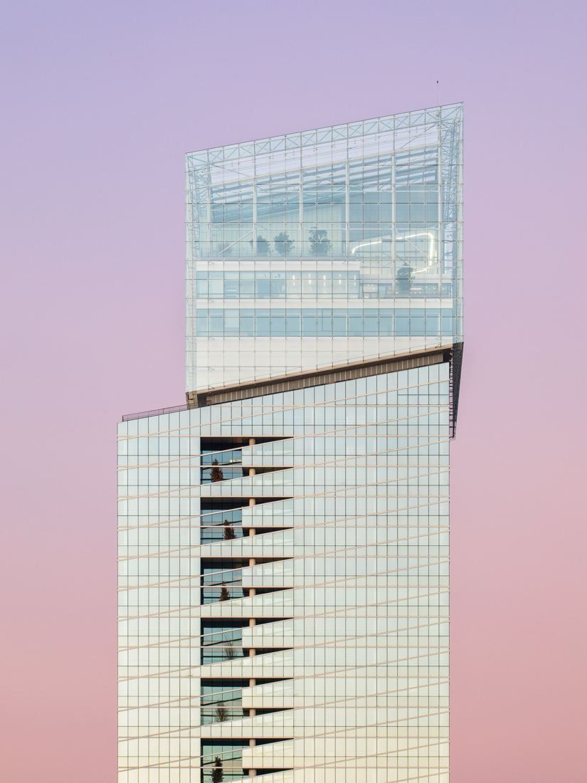 Saint-Gobain: Tall glass tower against a pink evening sky