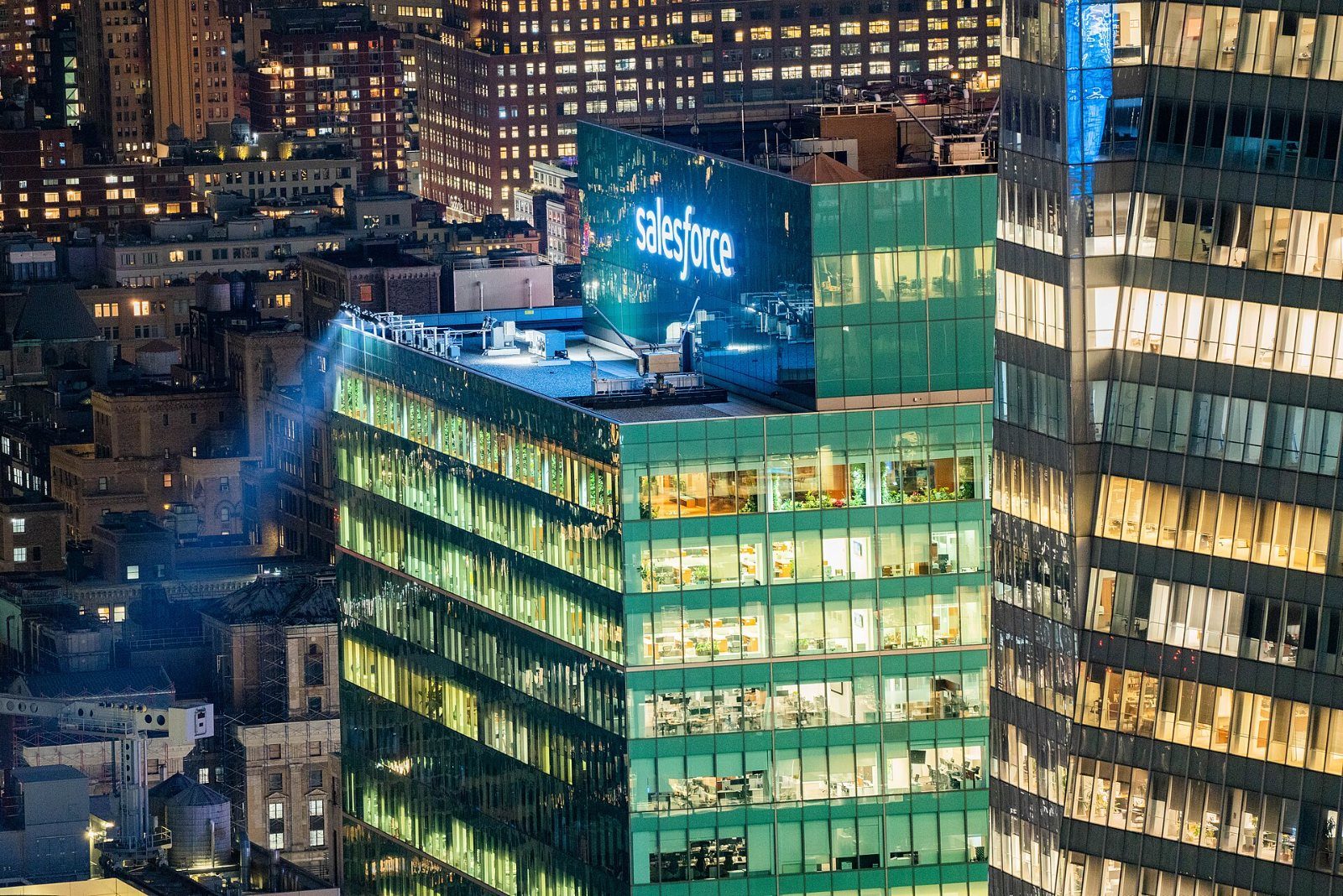 Salesforce: Office tower lit at night with a Salesforce sign