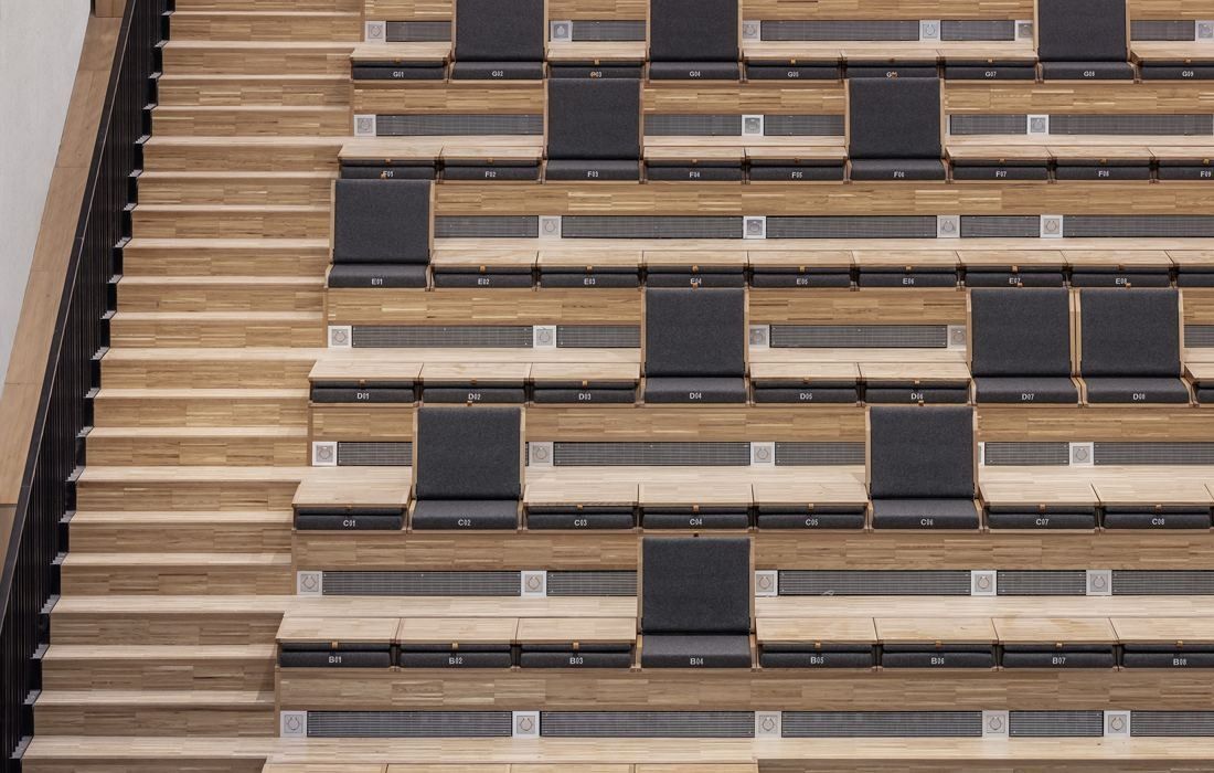 Sanofi: Tiered wooden steps with dark cushions arranged in a staggered pattern
