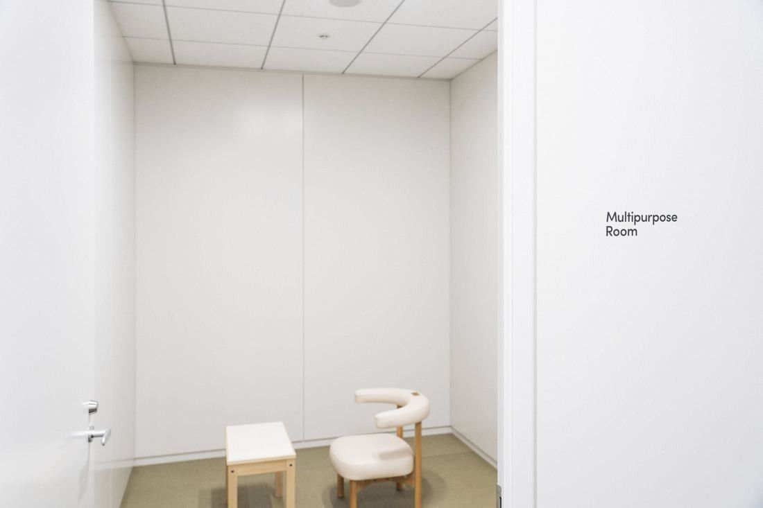 Sansan: Small white room with an armchair and a stool, signed Multipurpose Room